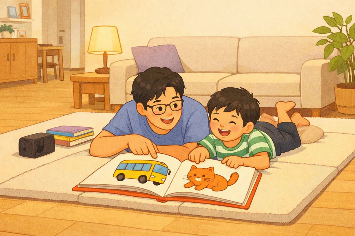 저녁 거실 매트에 엎드린 아빠와 아이가 그림책을 함께 보며 그림을 손가락으로 가리키고 있다