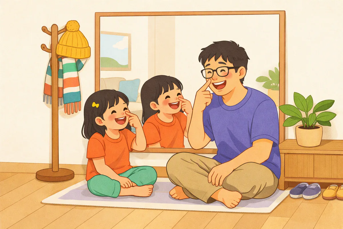 거울 앞에서 아빠와 딸이 함께 코를 가리키며 웃고, 옆 옷걸이에 모자와 목도리가 걸려 있다